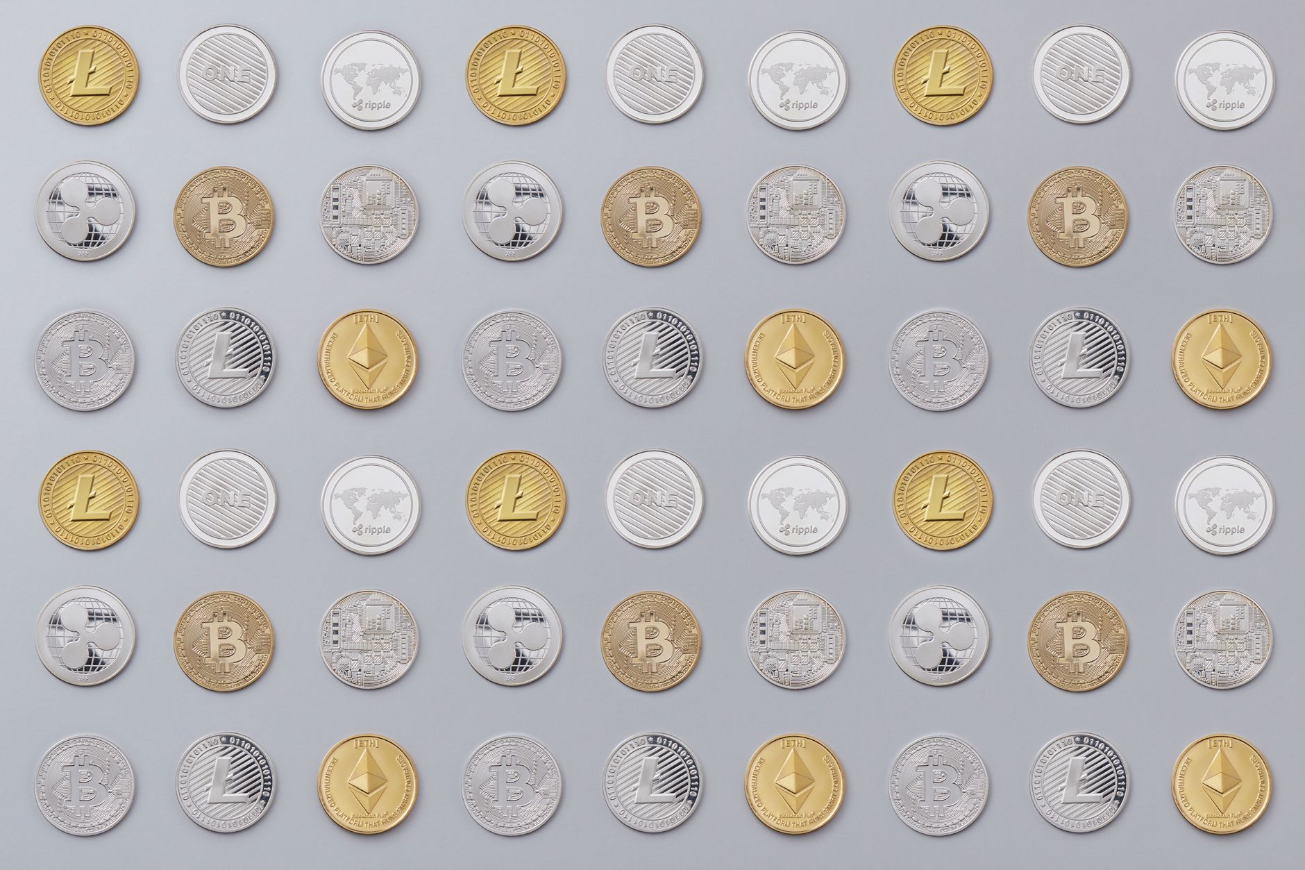 A seamless pattern of various cryptocurrency coins in gold and silver tones.