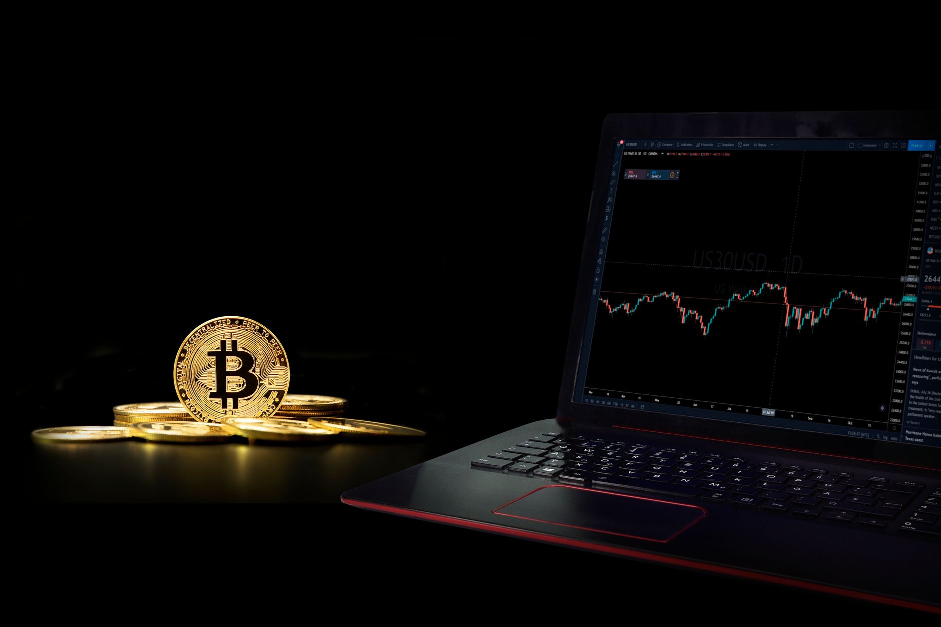 Golden bitcoin coins next to a laptop displaying a trading graph, symbolizing digital currency investment.