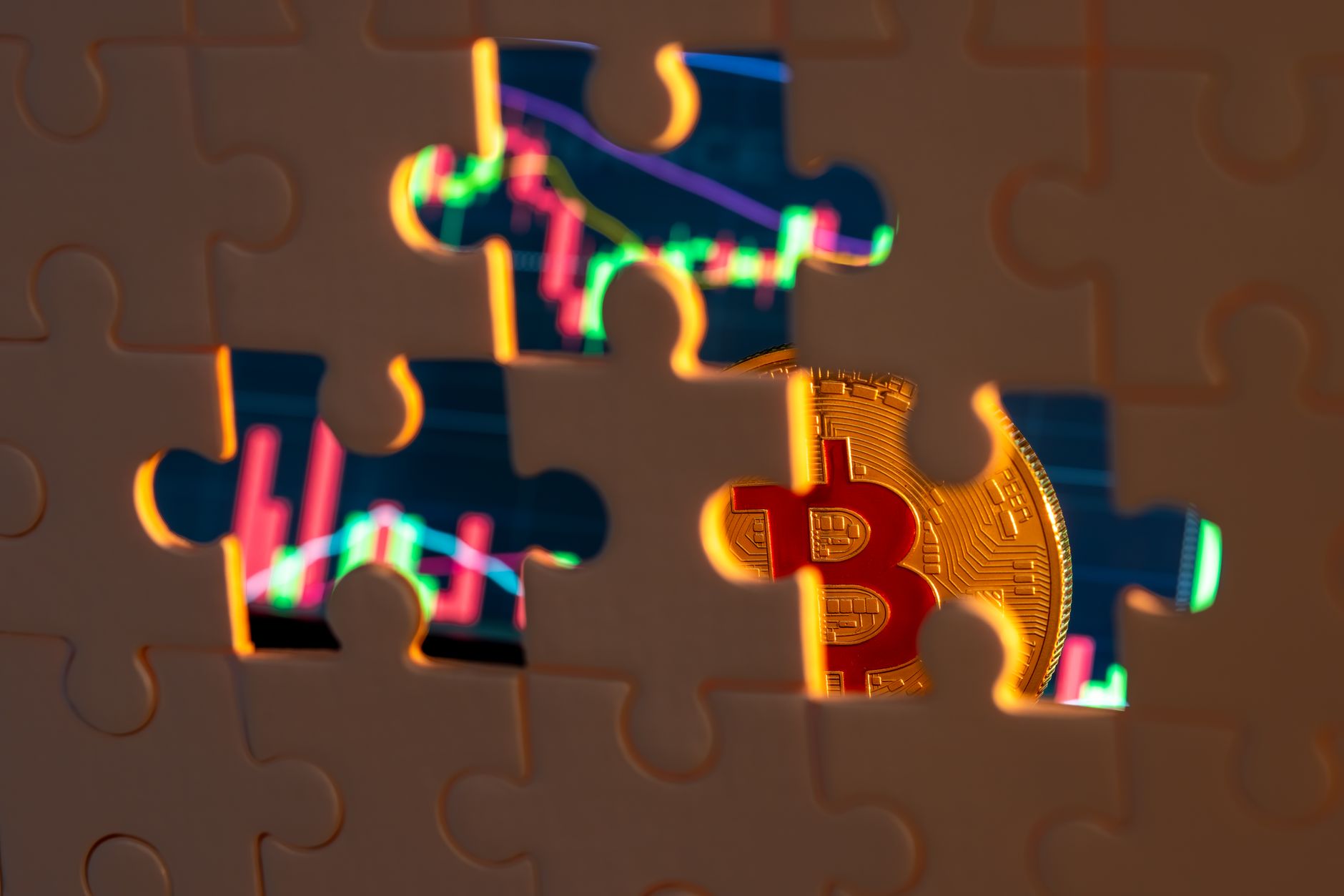 A bitcoin coin revealed through puzzle pieces with financial graphs in the backdrop.